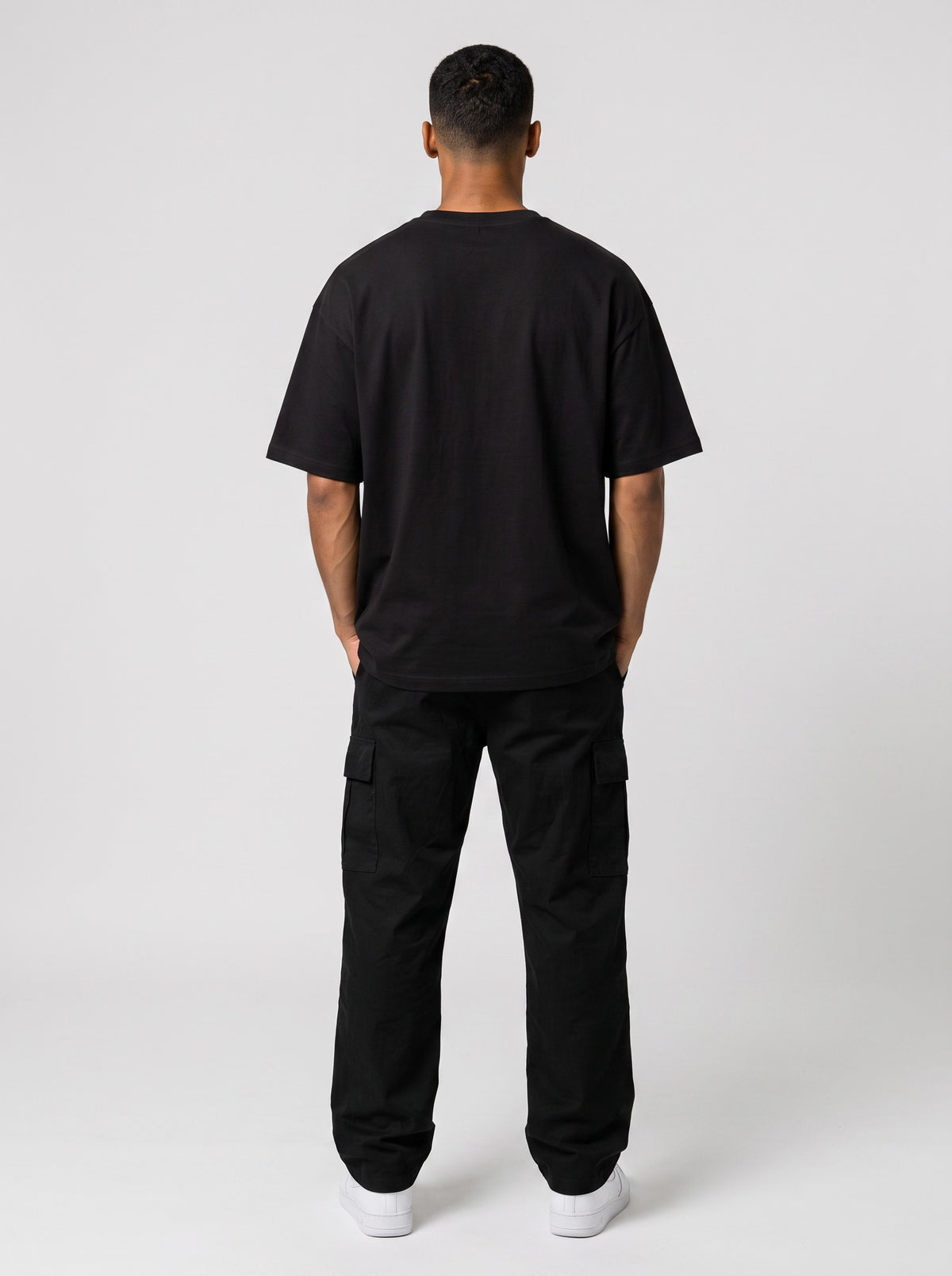 Ambition Limitless black organic cotton oversized t-shirt with drop shoulders, back view on a male model.