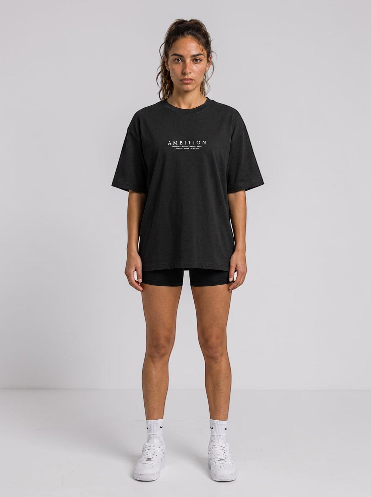 Ambition Limitless black organic cotton oversized t-shirt with drop shoulders and white chest logo on a model