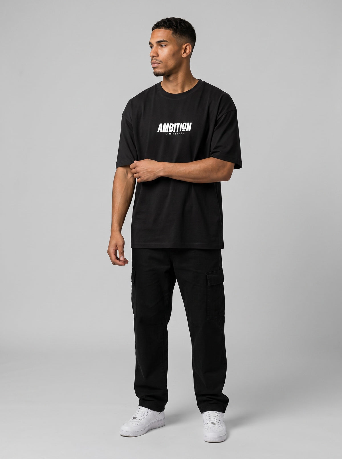 Ambition Limitless black organic cotton oversized t-shirt with white logo print worn by a man