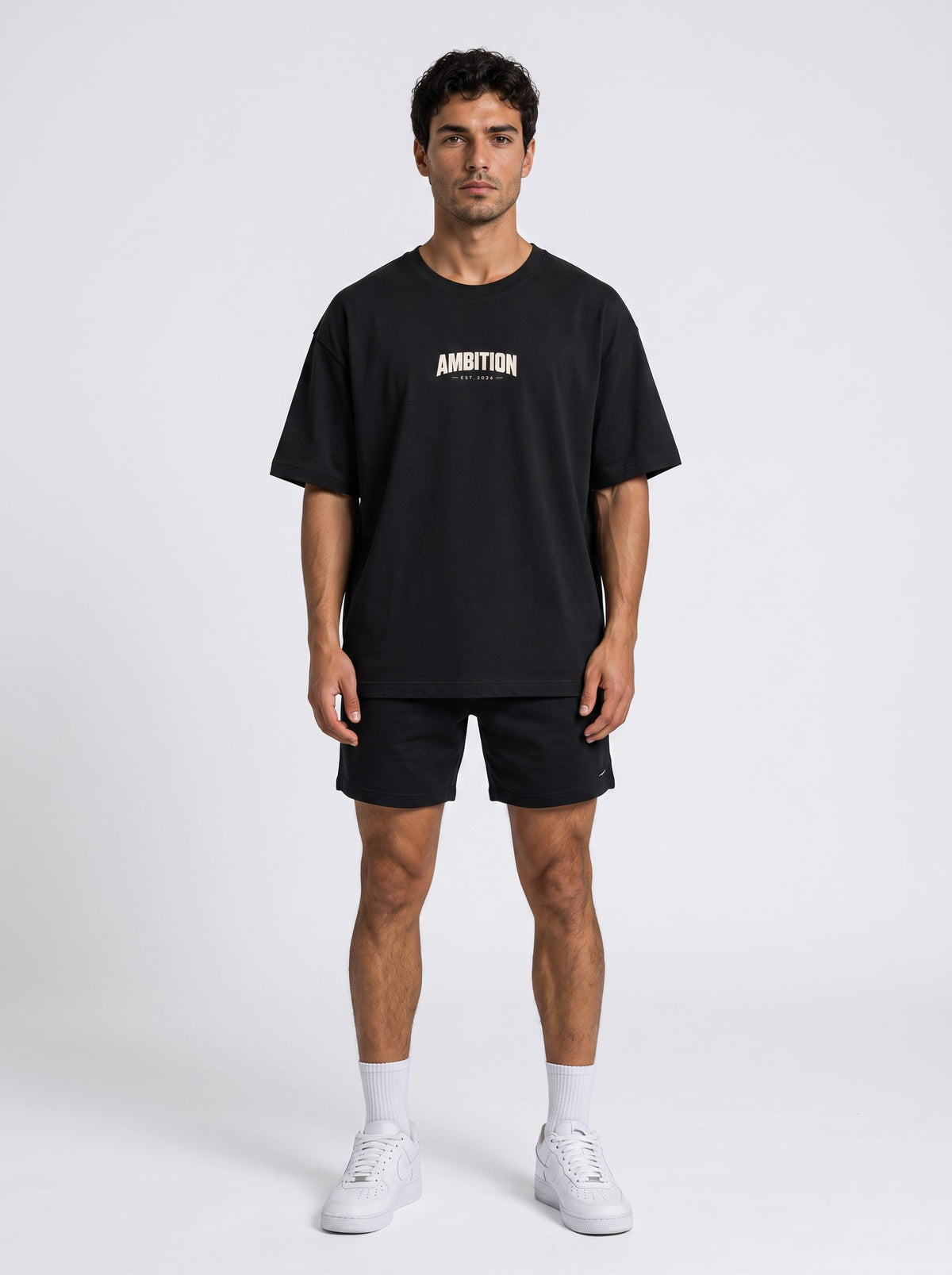 Ambition Limitless black organic cotton oversized t-shirt with drop shoulders and white chest logo on a male model