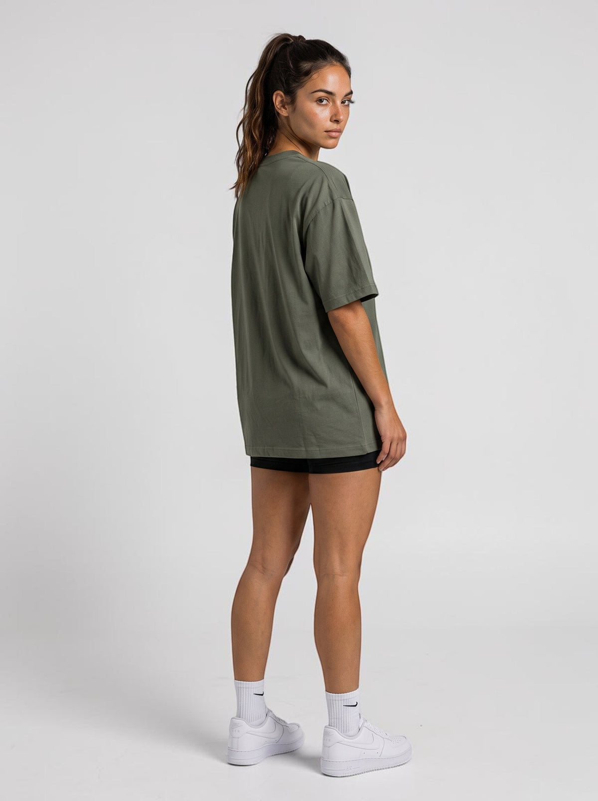 Ambition Limitless olive green organic cotton oversized t-shirt with dropped shoulders worn by a model, back view