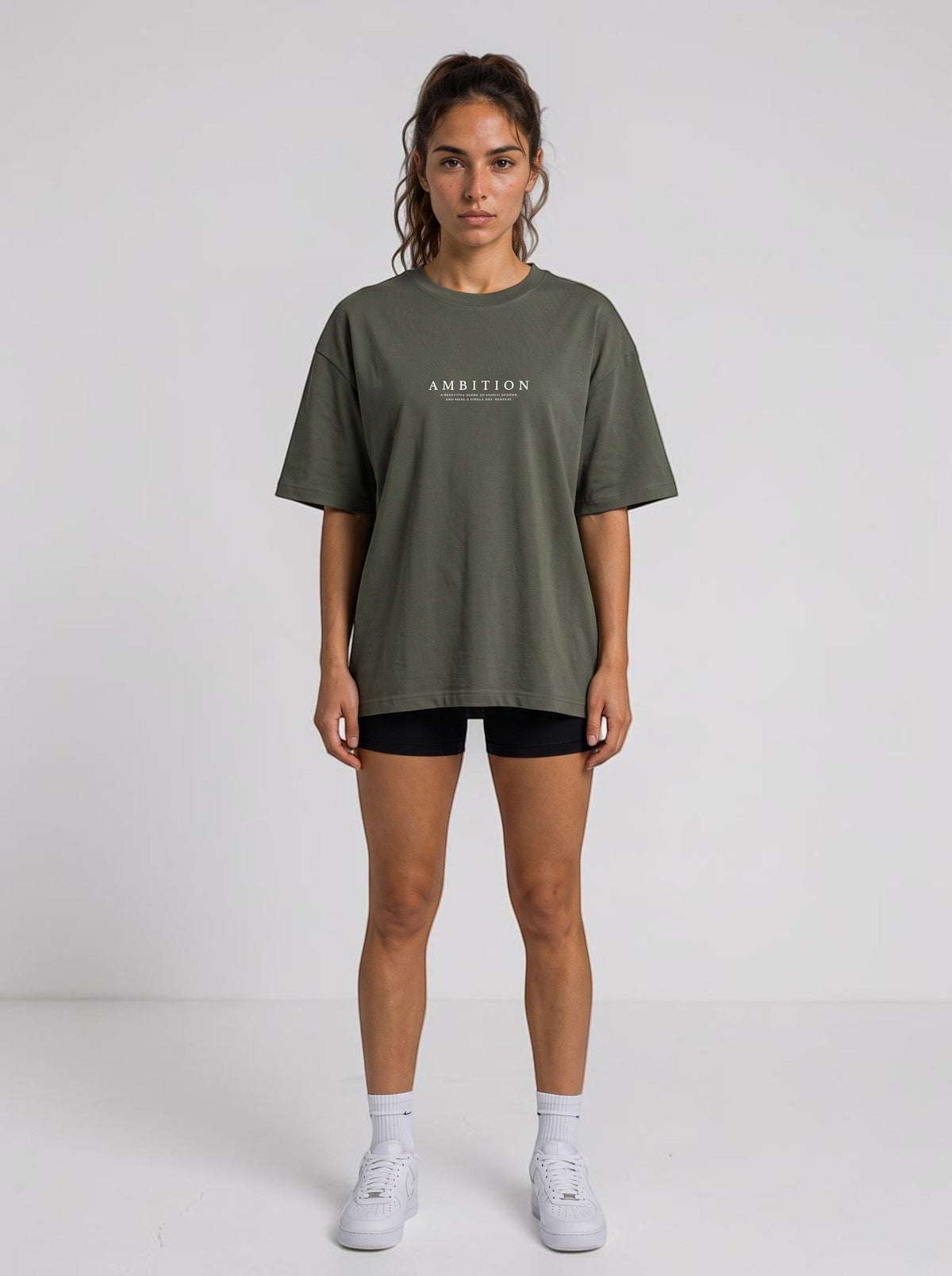 Woman wearing an Ambition Limitless olive green organic cotton oversized t-shirt with dropped shoulders