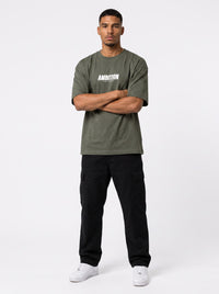 Ambition Limitless olive green heavyweight organic cotton oversized t-shirt with white chest logo on a male model