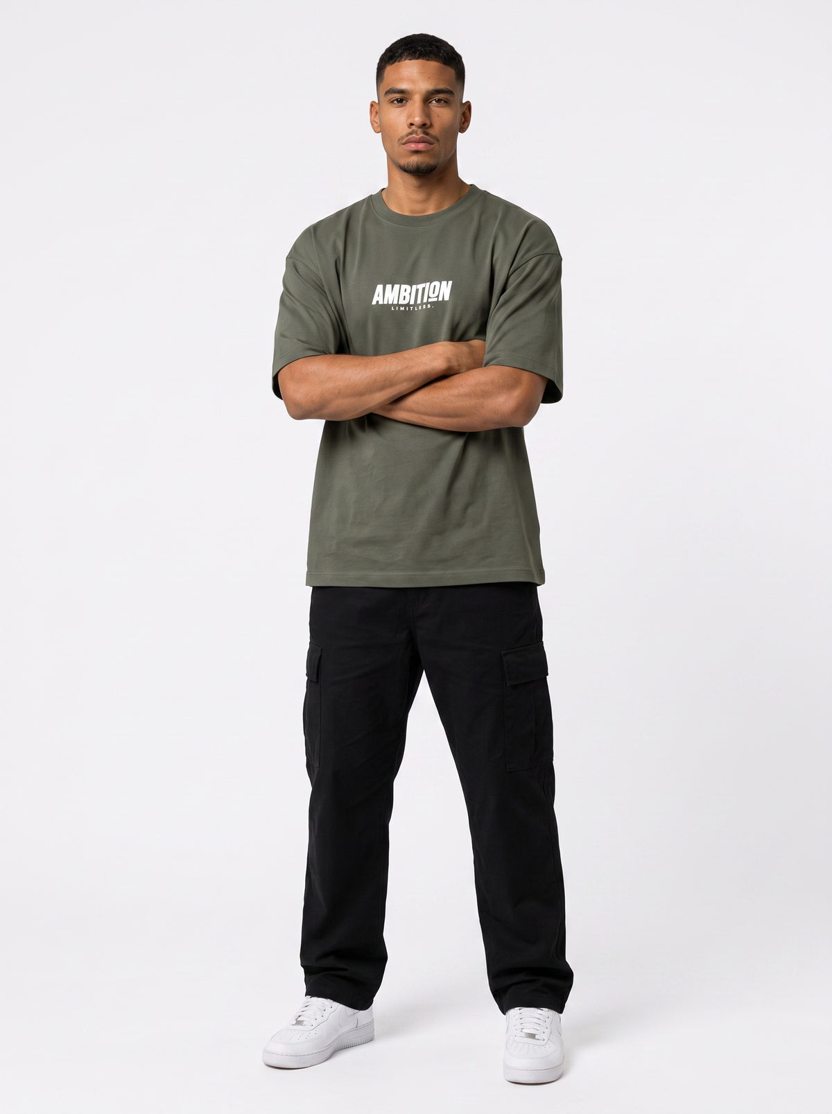 Ambition Limitless olive green heavyweight organic cotton oversized t-shirt with white chest logo on a male model