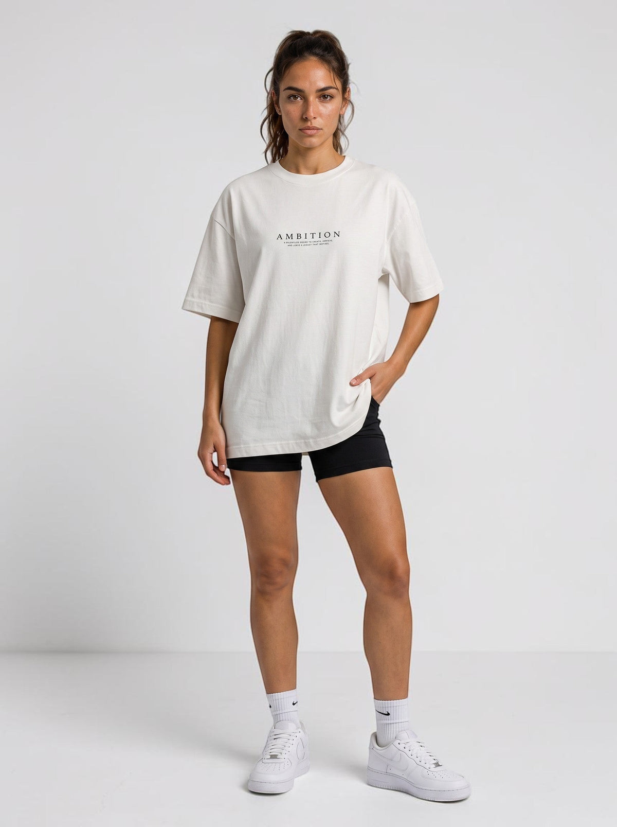 Ambition Limitless oversized beige organic cotton t-shirt with drop shoulders and black logo print on a model