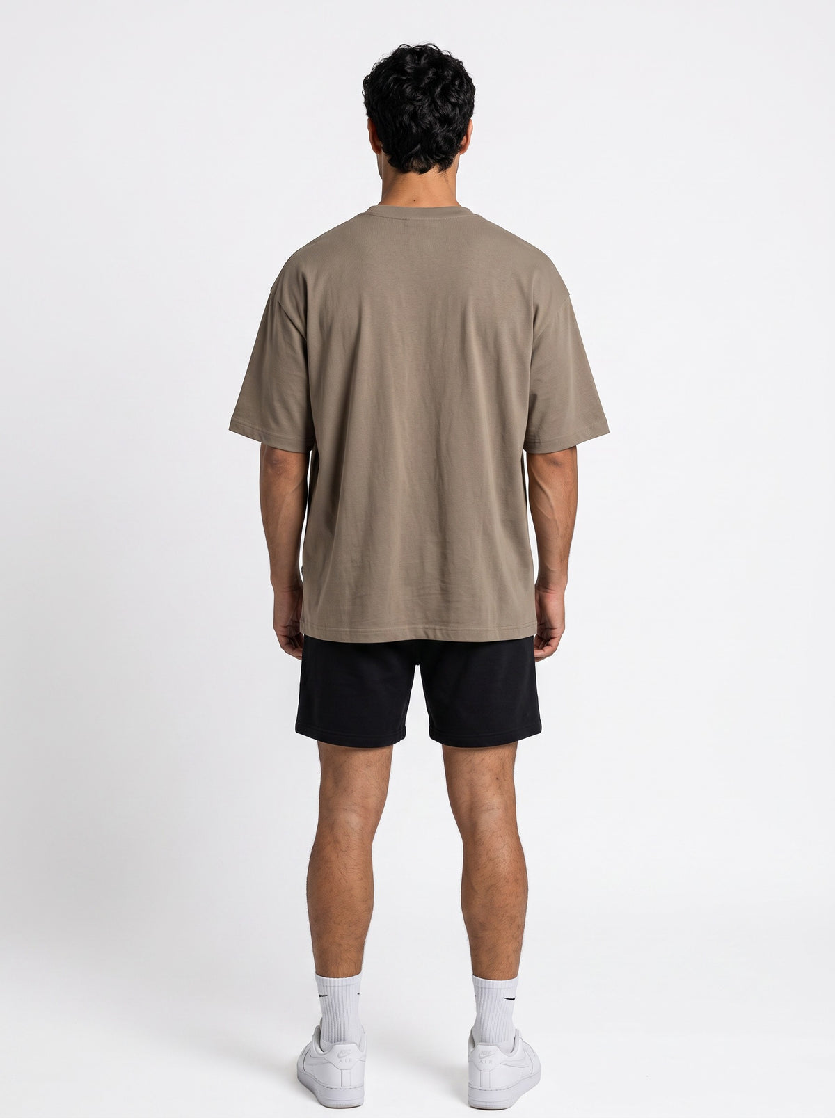 Ambition Limitless beige organic cotton oversized t-shirt with drop shoulders, back view on a male model.