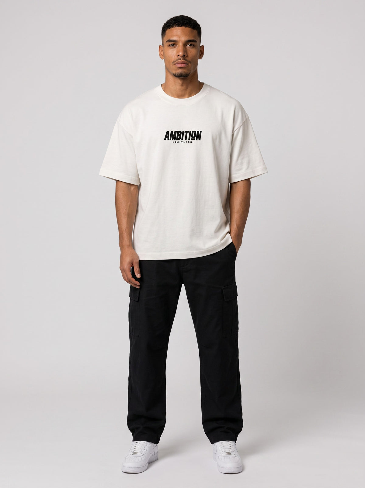 Ambition Limitless oversized off-white organic cotton t-shirt with black logo on chest worn by a male model