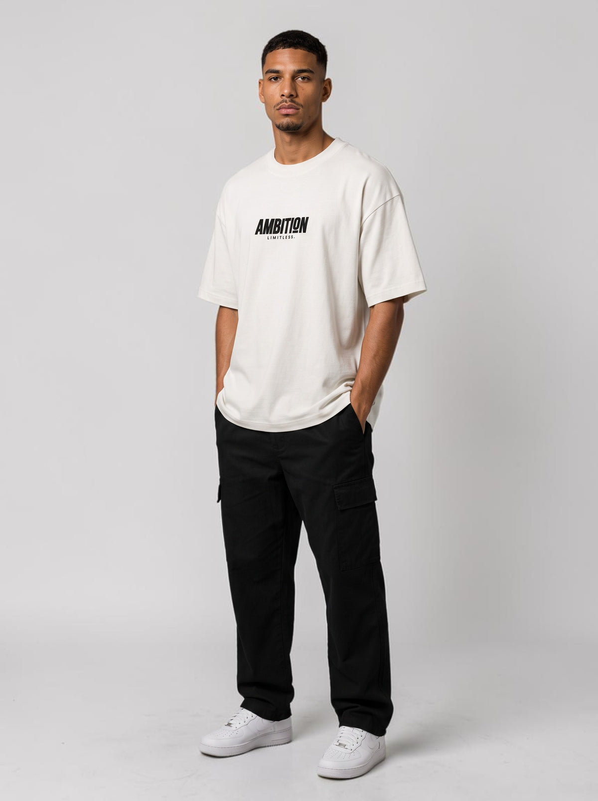 Ambition Limitless oversized off-white organic cotton t-shirt with black logo print and drop shoulders on a model