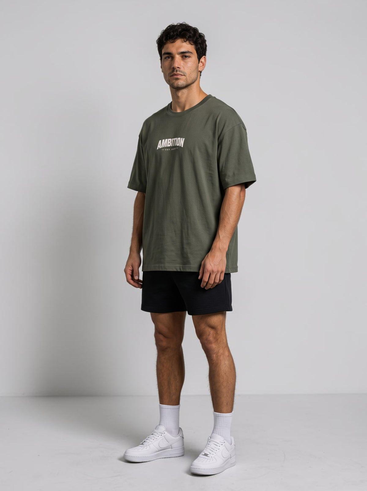 Ambition Limitless oversized olive green organic cotton t-shirt with drop shoulders worn by a male model
