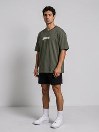 Ambition Limitless oversized olive green organic cotton t-shirt with drop shoulders worn by a male model