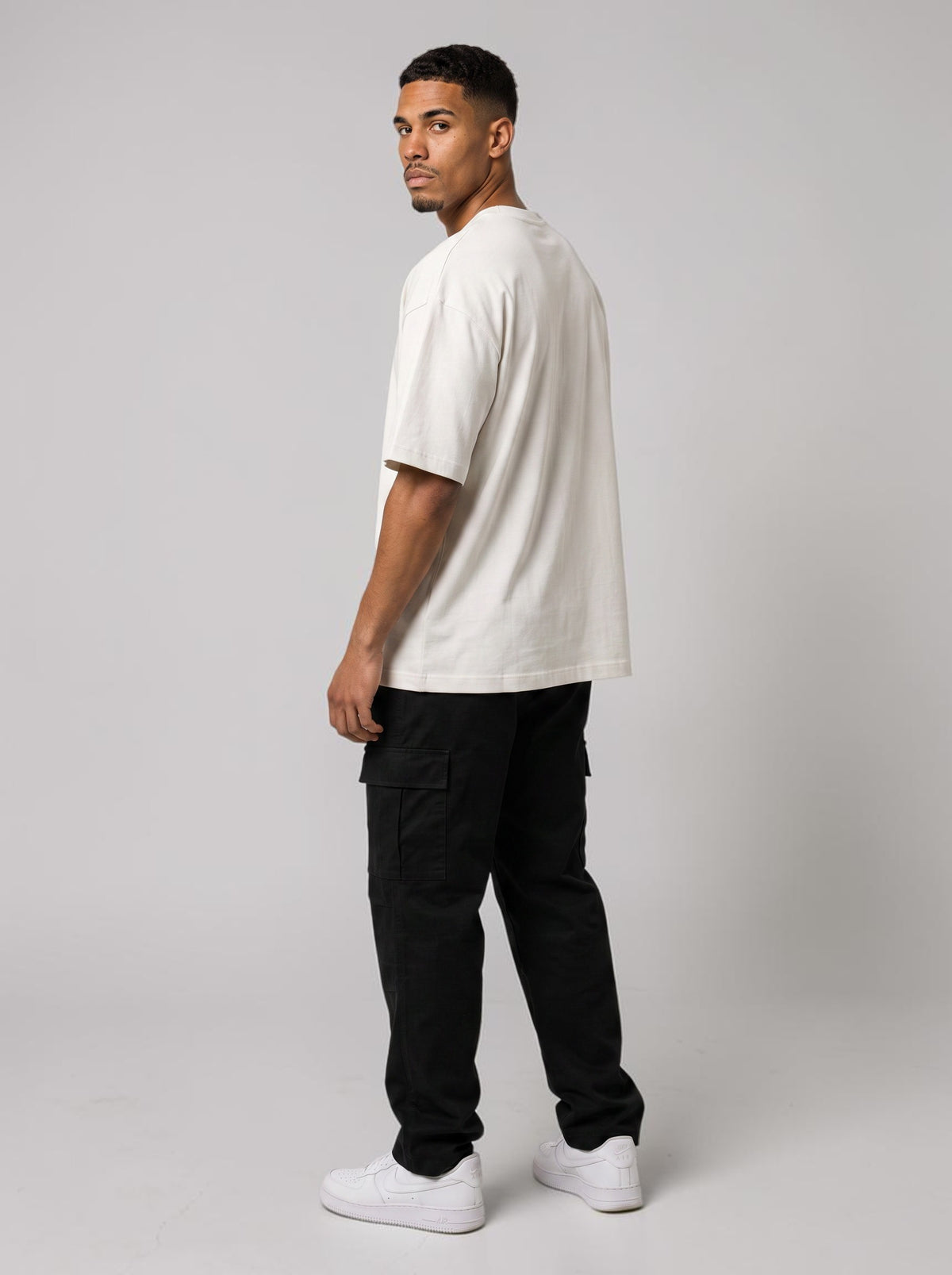 Ambition Limitless white organic cotton oversized t-shirt with dropped shoulders worn by a man from the back