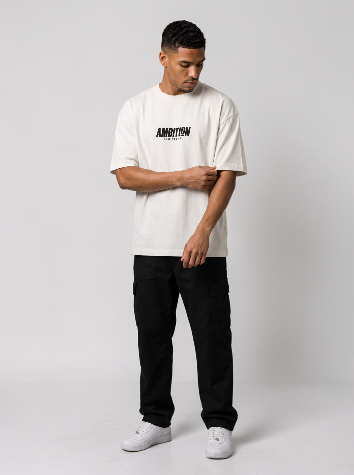 Ambition Limitless white oversized organic cotton t-shirt with black logo on chest worn by a male model